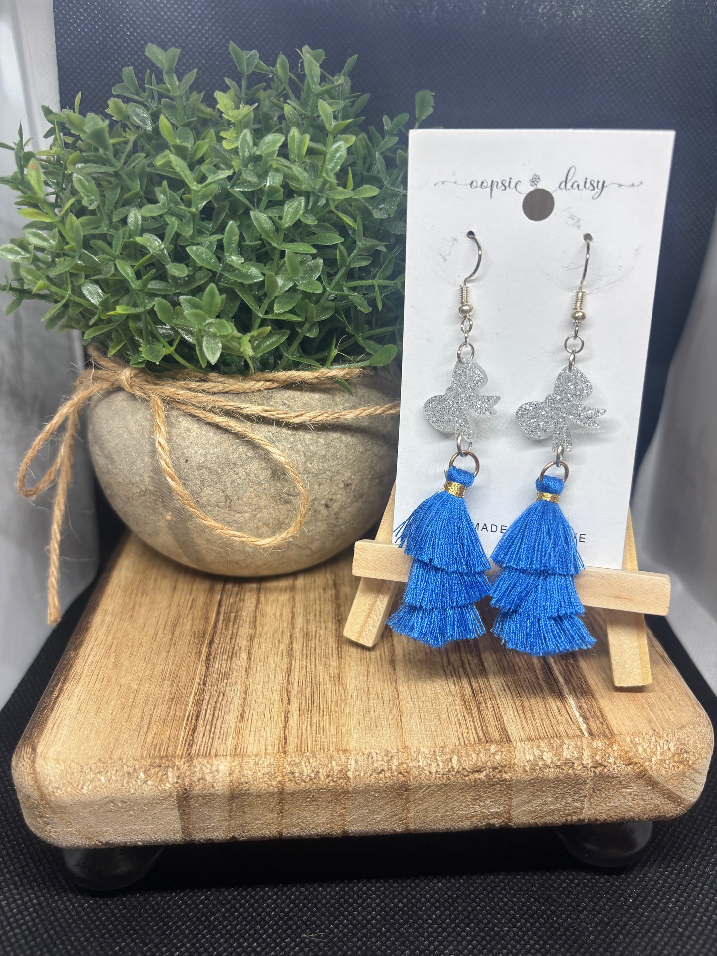Silver bow and blue tassels